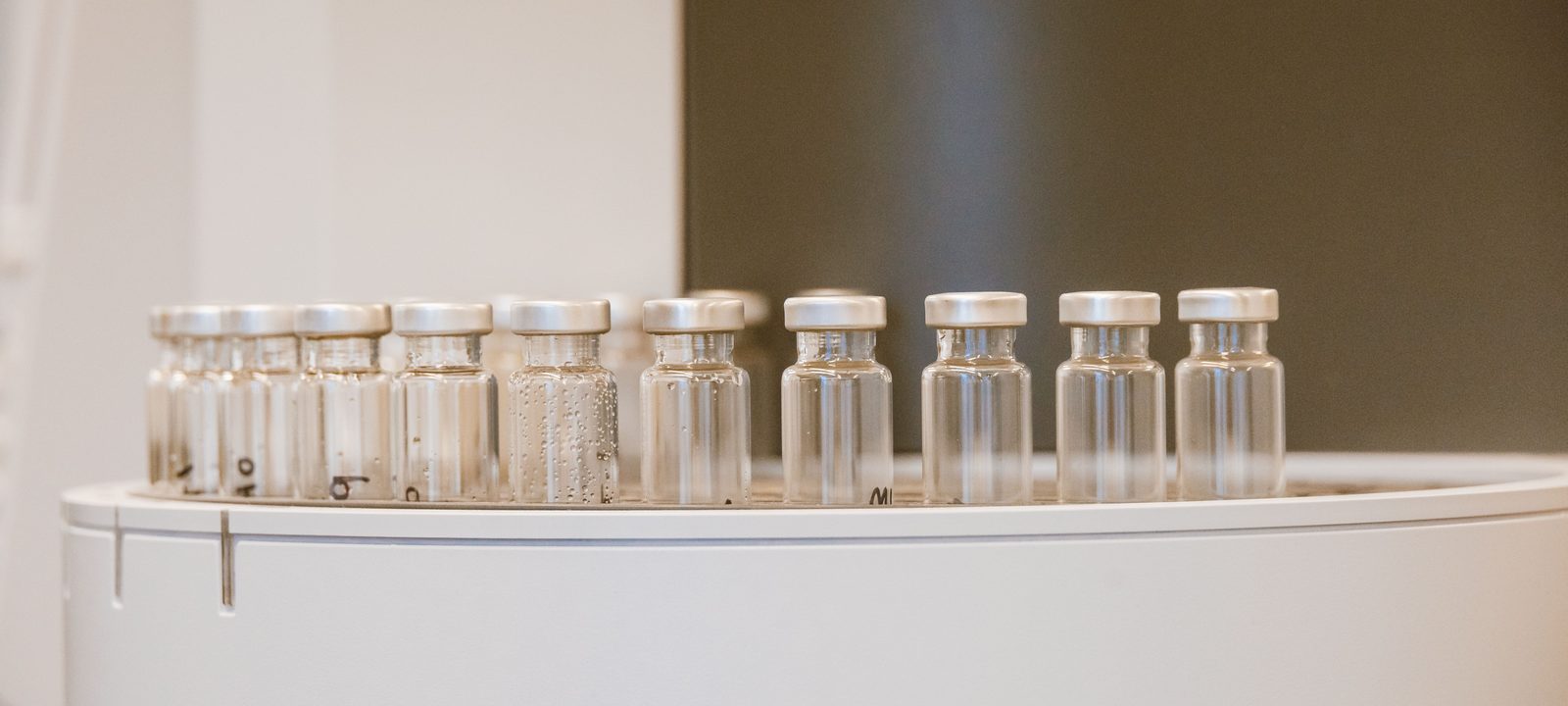 Close-up of empty glass vials arranged in a laboratory environment.