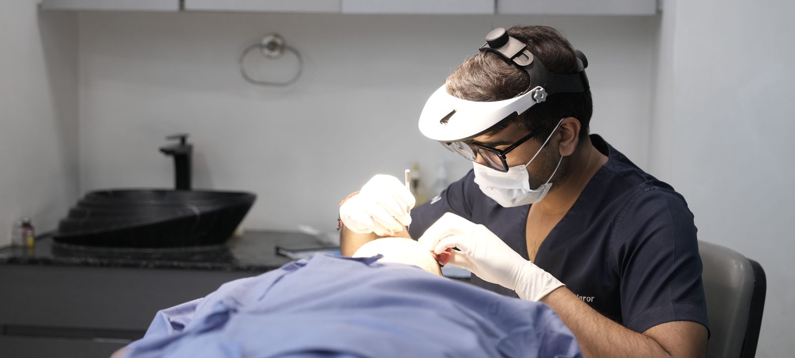 A dermatologist conducts a skin treatment on a patient in a modern clinic setting.